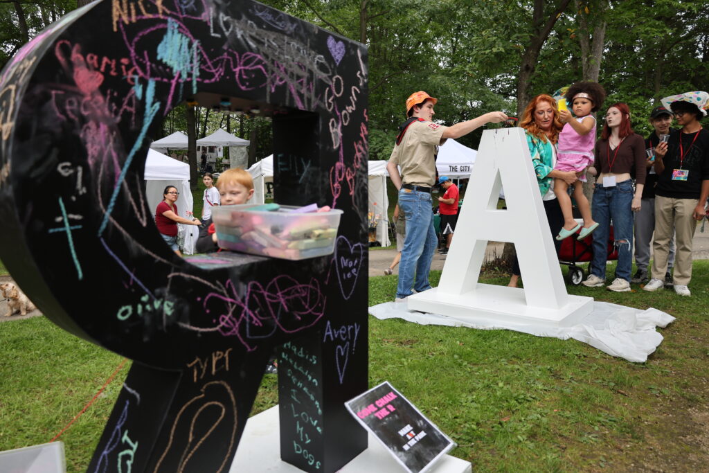 "ART" sign with chalk drawings on it