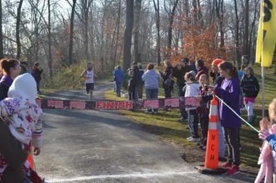 Runner about the cross the finish line